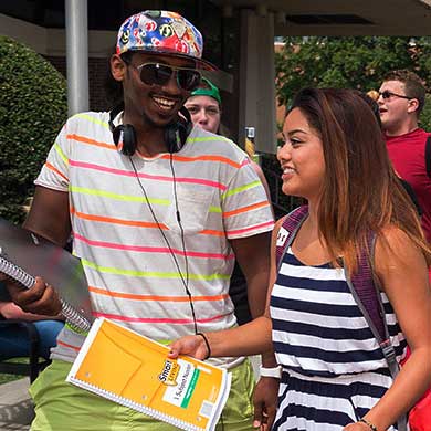 happy v.c.u. students walking together on campus on a sunny day