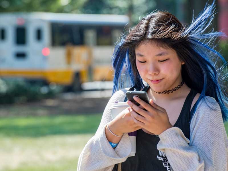 a student with the mobile in hand at the v.c.u. campus